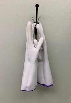 Figure 2: Gloves were turned inside out, washed with antimicrobial soap, and hung overnight by clipping the fingertips with a binder clip to air dry.