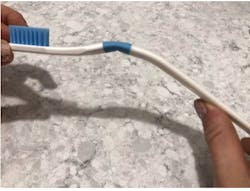 Figure 3: When greater than 150 g of pressure is applied to the ZentFlex toothbrush, it bends and emits a &apos;clicking&apos; sound at the blue junction of the neck and handle of the toothbrush.