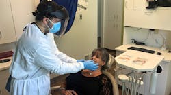 Radwan Almomani, DMD, administers a COVID-19 test to a patient at Refresh Dental in New Castle, Pennsylvania. Radwan Almomani, DMD, administers a COVID-19 test to a patient at Refresh Dental in New Castle, Pennsylvania.