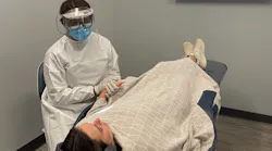 The assistant of Vitalize Dental comforts a nervous patient.