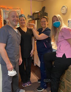 Dr. Thomas with his team, from left, Sarah Guay, assistant, Justine Repolt, assistant, aka spider watcher, and Chelsea Loignon, receptionist.