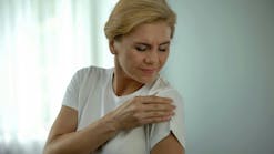 Woman with achy shoulder muscles