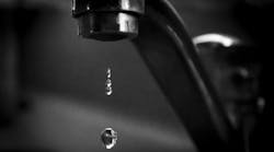 Water drips from a faucet, highlighting the impact of fluoride removal on public health Water drips from a faucet, highlighting the impact of fluoride removal on public health