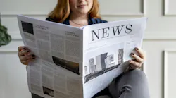 woman reading newspaper