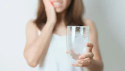 woman holding glass of water woman holding glass of water