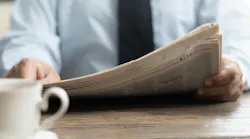 person reading newspaper