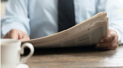 person reading newspaper person reading newspaper