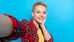 Woman with veneers posing for a selfie Woman with veneers posing for a selfie