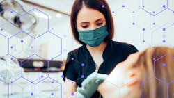 Female dentist wearing mask examines female patient Female dentist wearing mask examines female patient