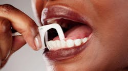 Woman using dental pick floss Woman using dental pick floss