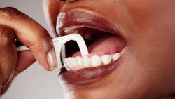 Woman using dental pick floss Woman using dental pick floss