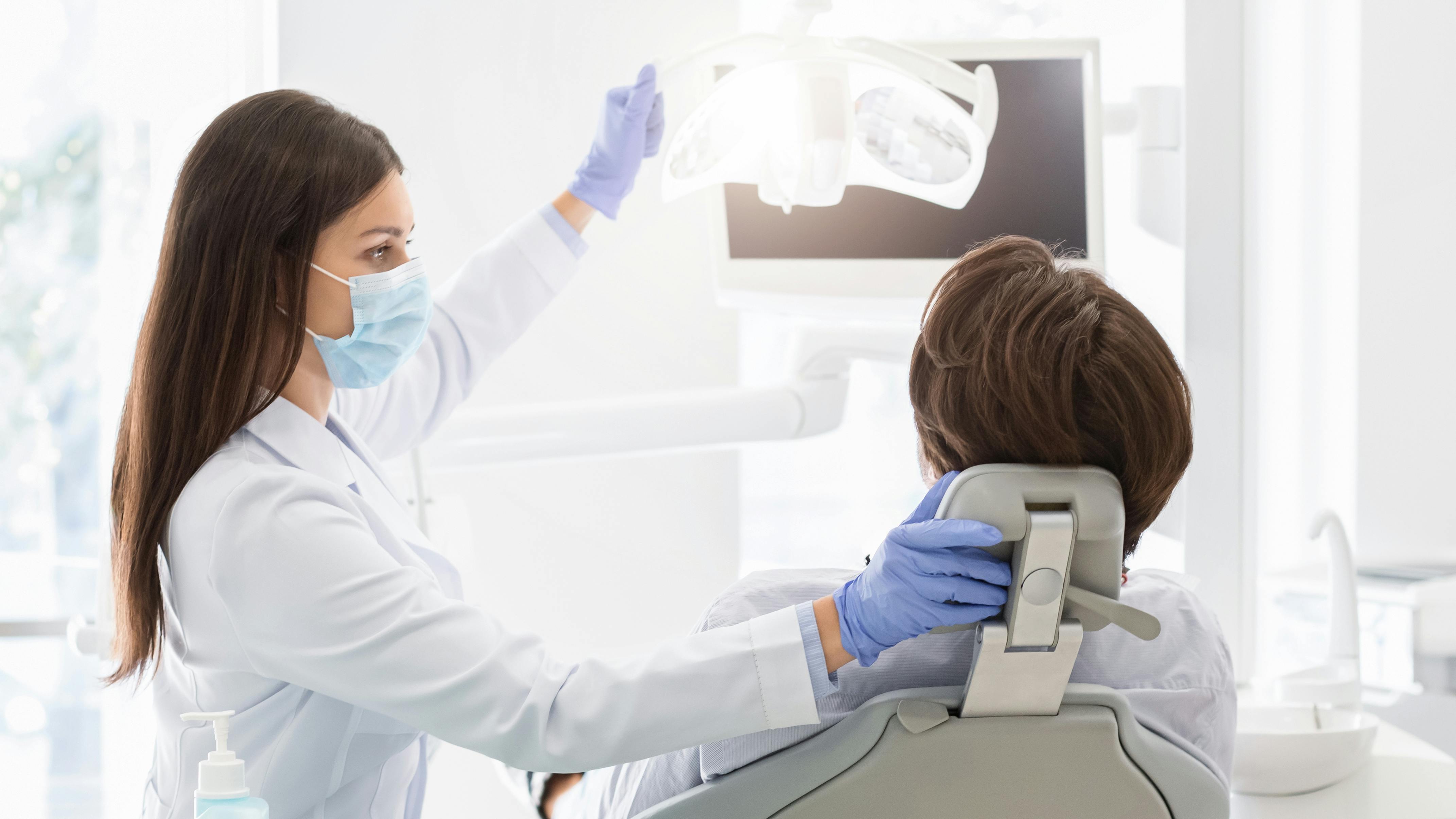 A dentist with a patient in the operatory