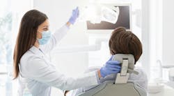 A dentist with a patient in the operatory A dentist with a patient in the operatory