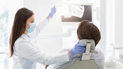 A dentist with a patient in the operatory A dentist with a patient in the operatory