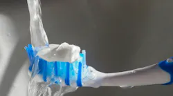 water on toothbrush with toothpaste