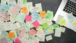 Desk with laptop and sticky notes Desk with laptop and sticky notes