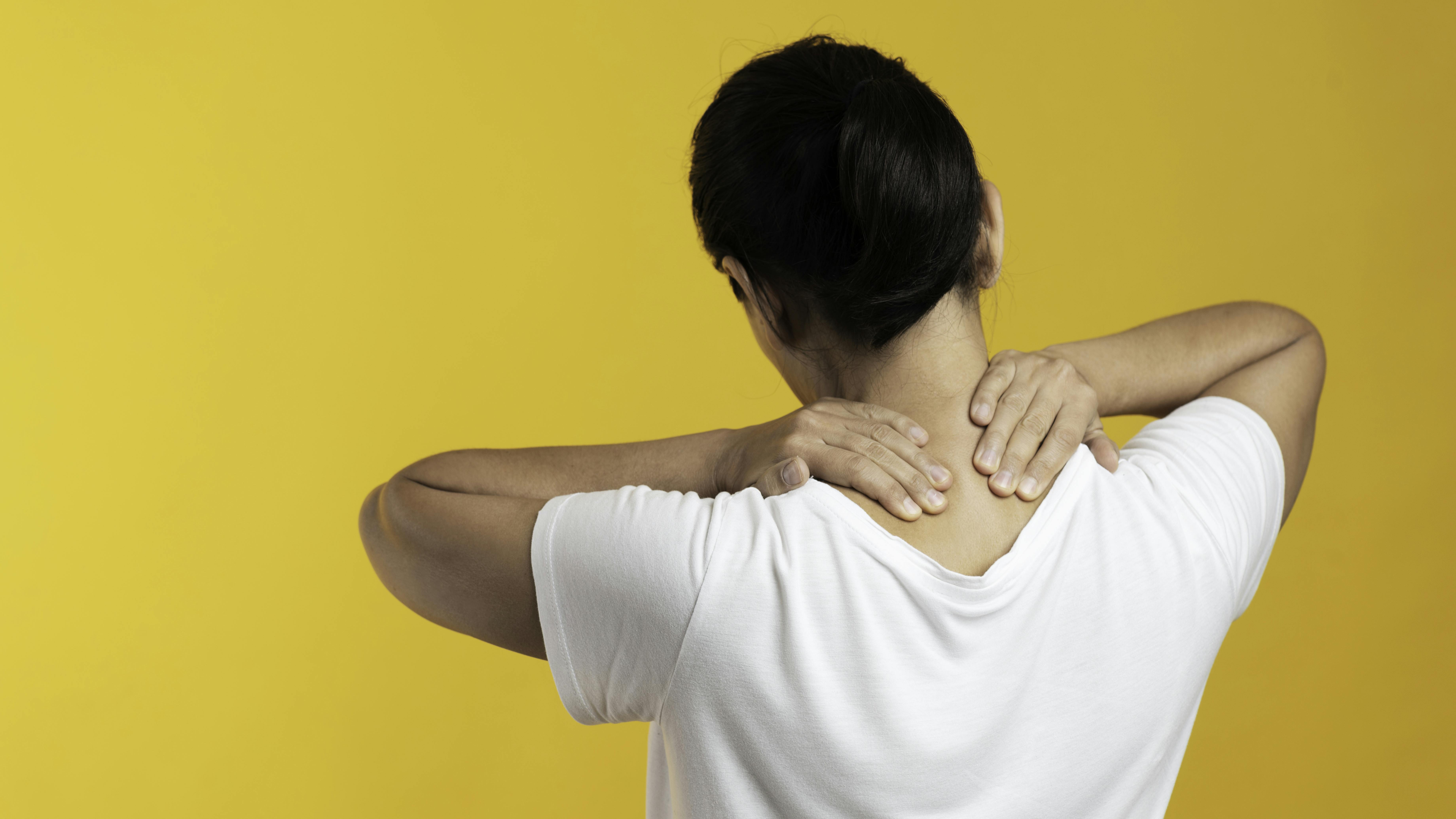 individual with hands on neck