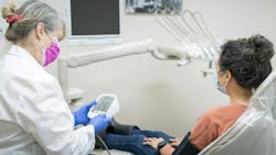 woman getting her blood pressure taken at the dentist's office woman getting her blood pressure taken at the dentist's office