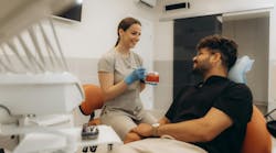dental professional talking to a patient in the dental chair dental professional talking to a patient in the dental chair
