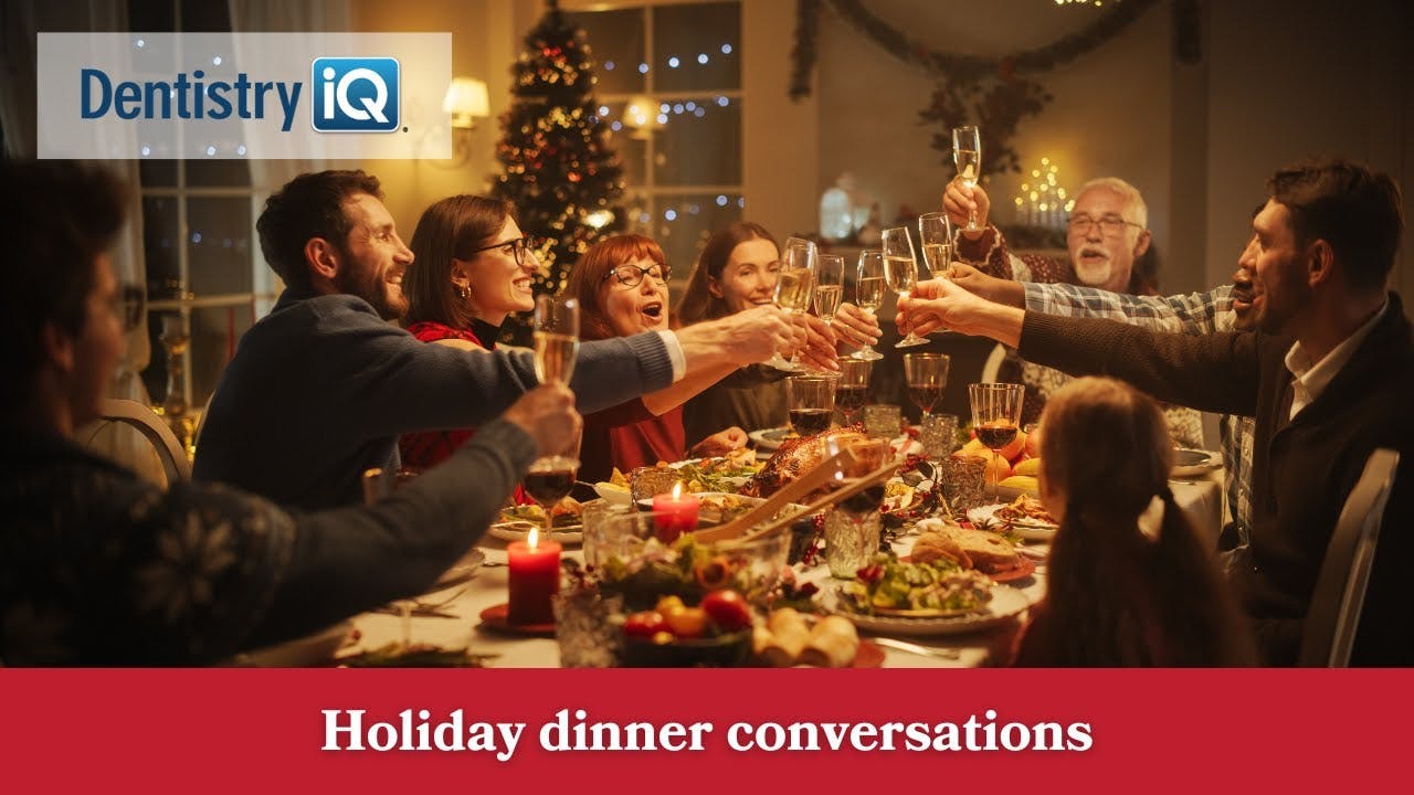 people sitting around a holiday dinner table making a toast