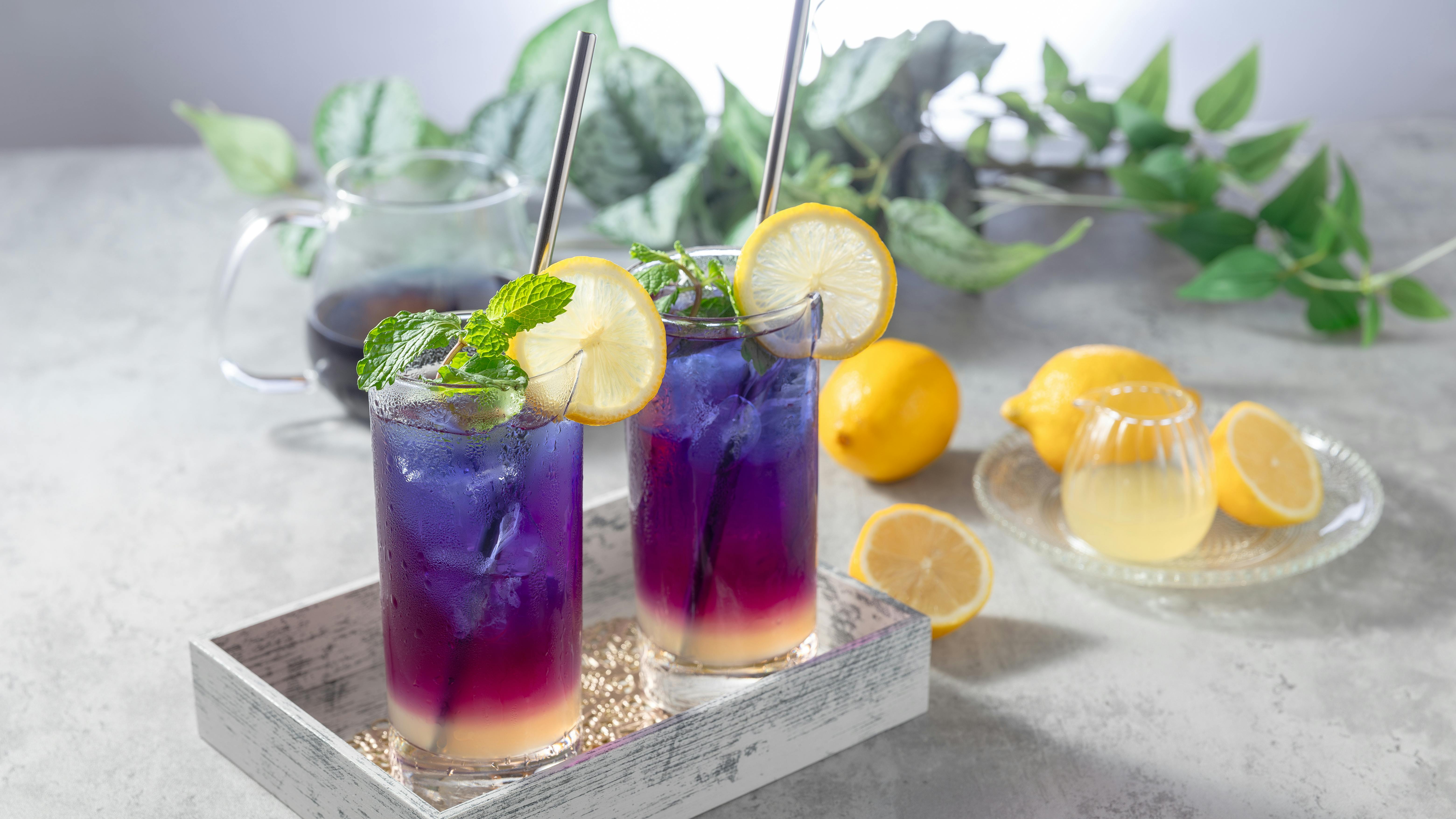 mocktails arranged on a tray with some lemons on the side