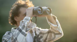 person looking through binoculars person looking through binoculars
