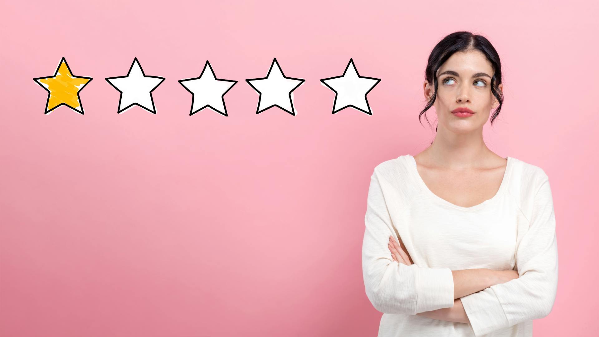 Woman with arms crossed and a one-star review