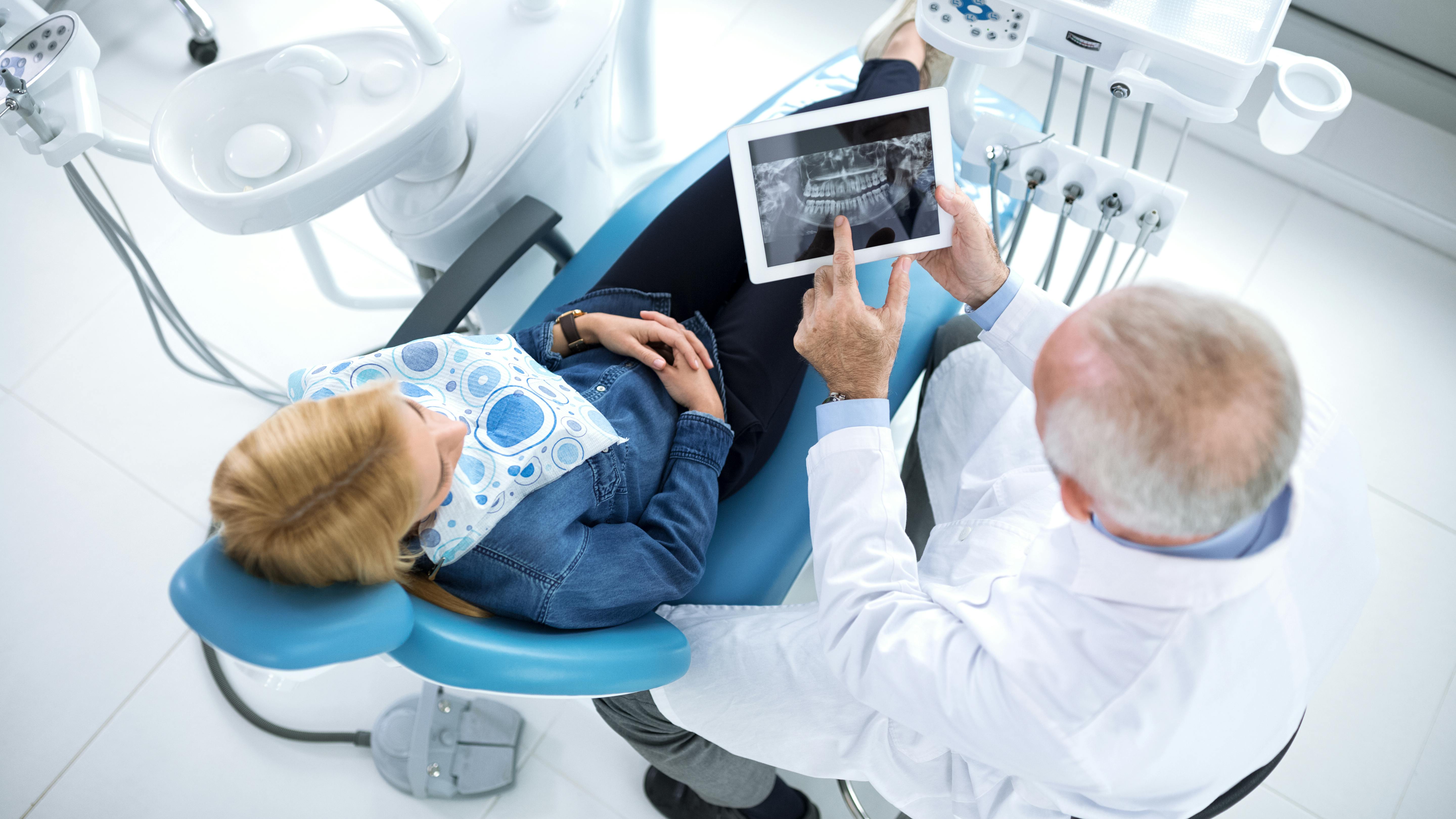 Dentist showing patient dental xrays