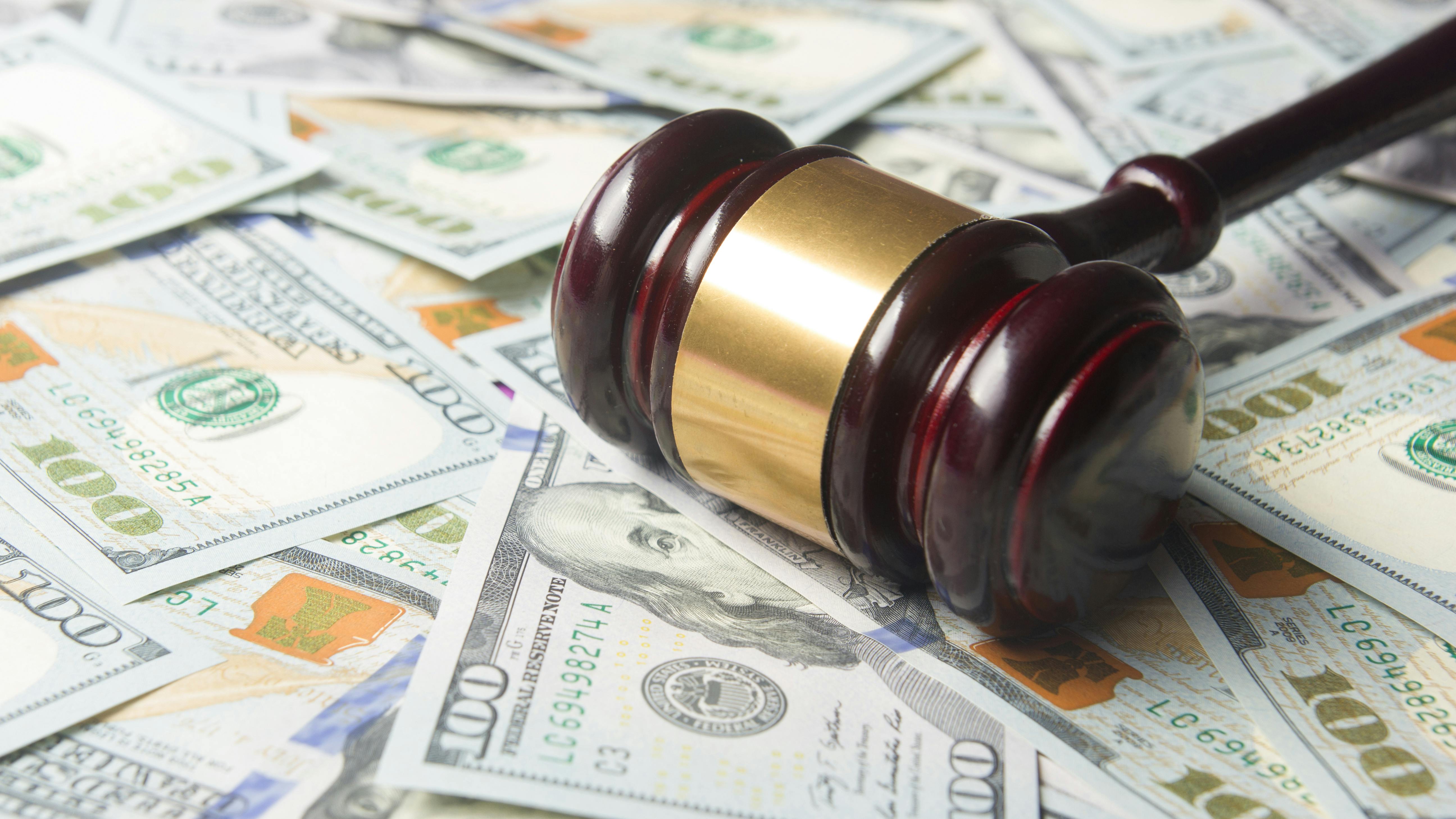 Court gavel on money representing legal settlement