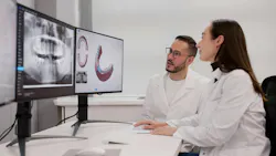 two dentists looking at 3D scans on screens two dentists looking at 3D scans on screens