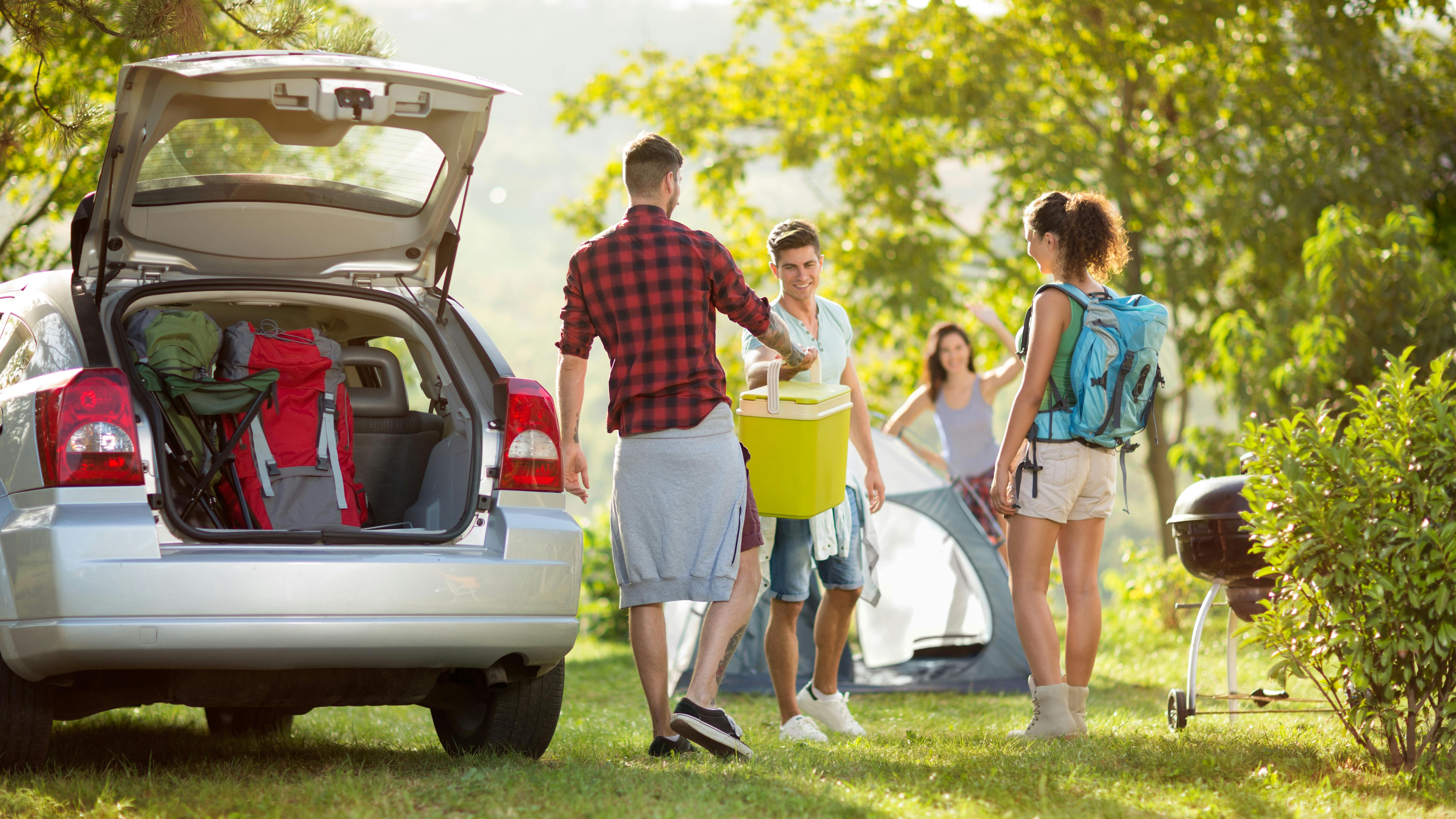 a family unpacking their car on vacation
