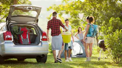 a family unpacking their car on vacation