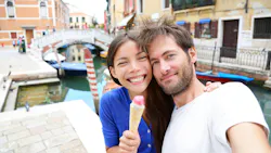 a woman and a man in Italy taking a selfie and holding a gelato