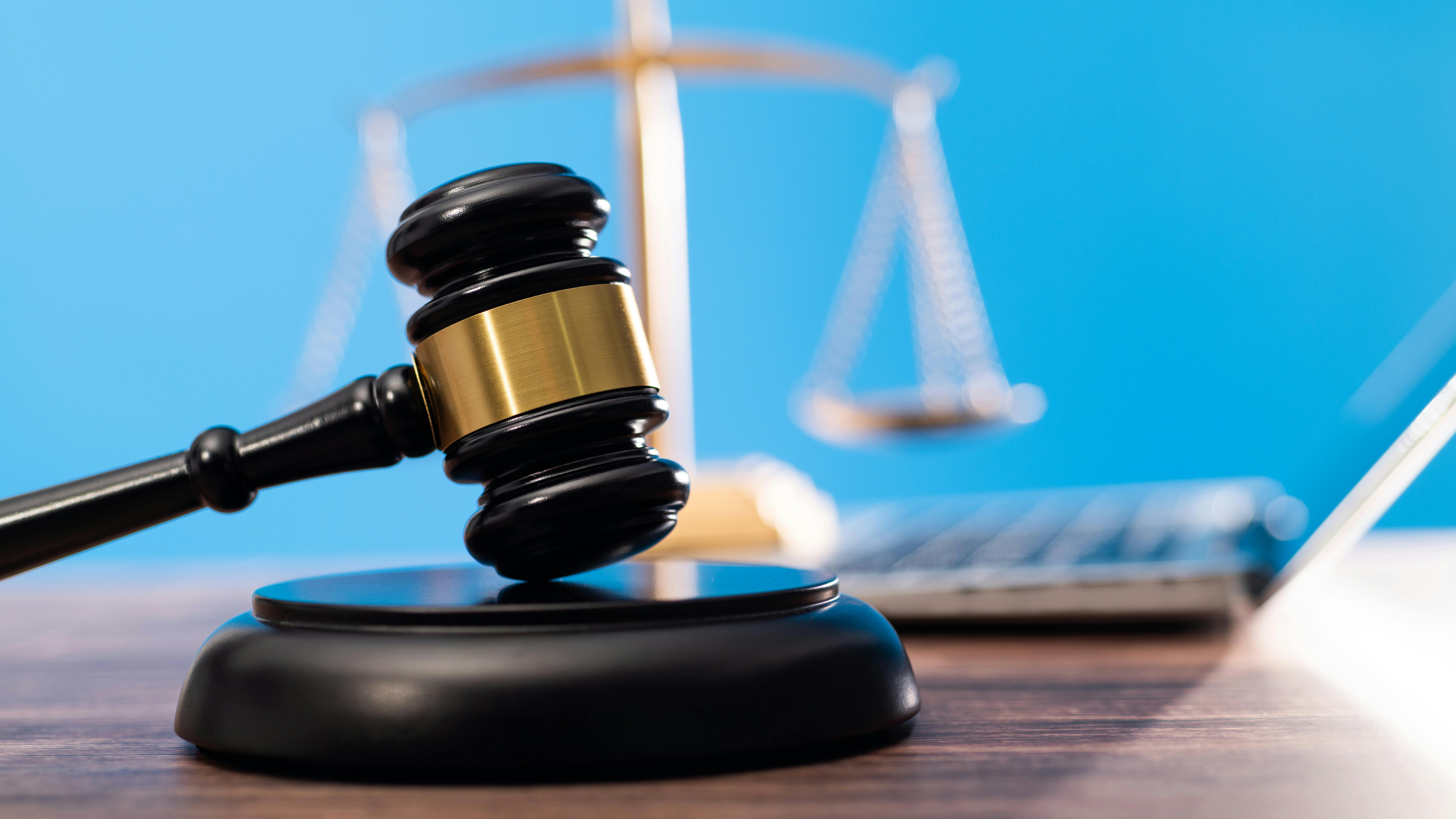 gavel with the scales of justice in the background