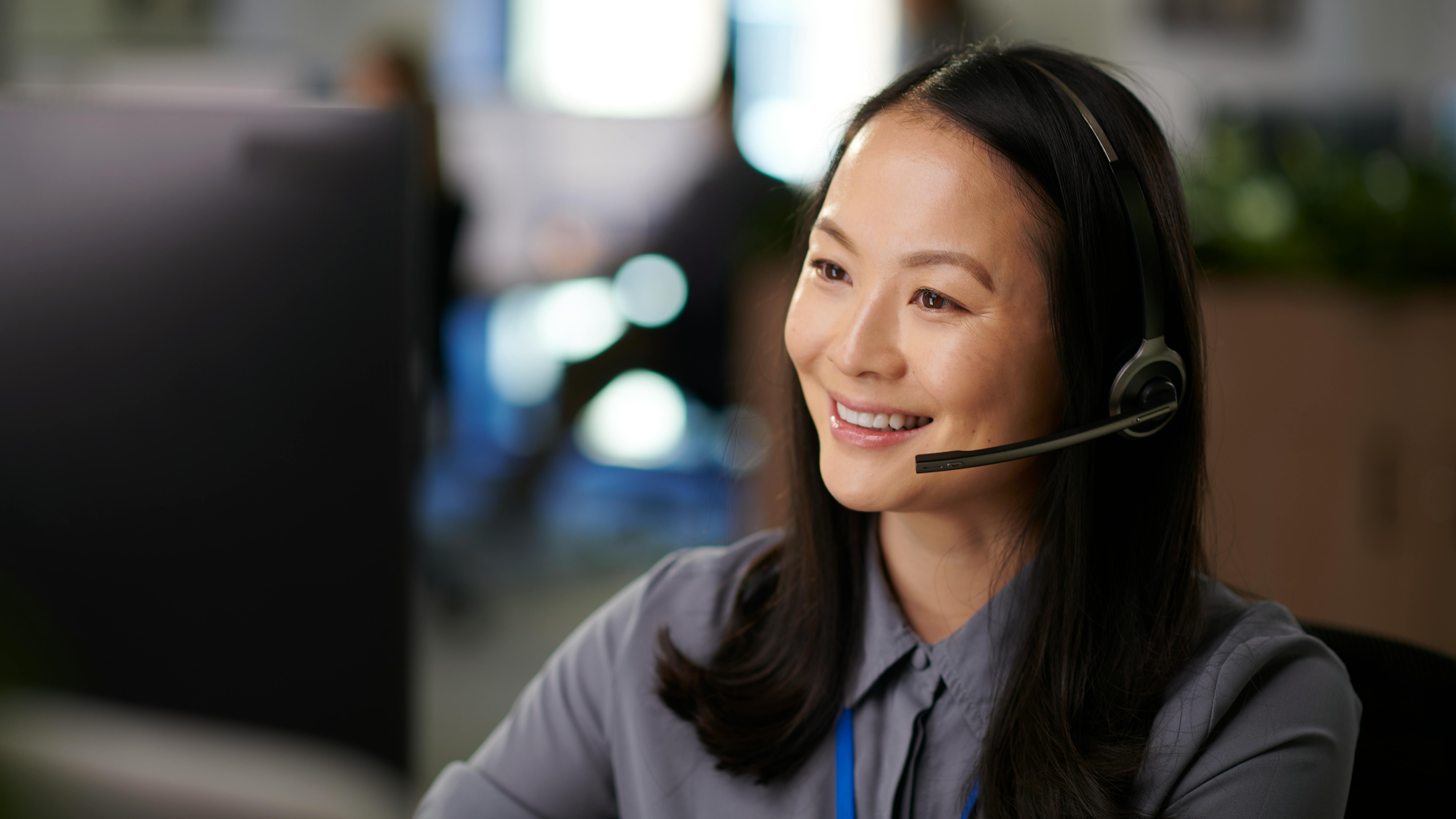 a smiling receptionist on the phone