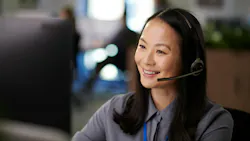 a smiling receptionist on the phone