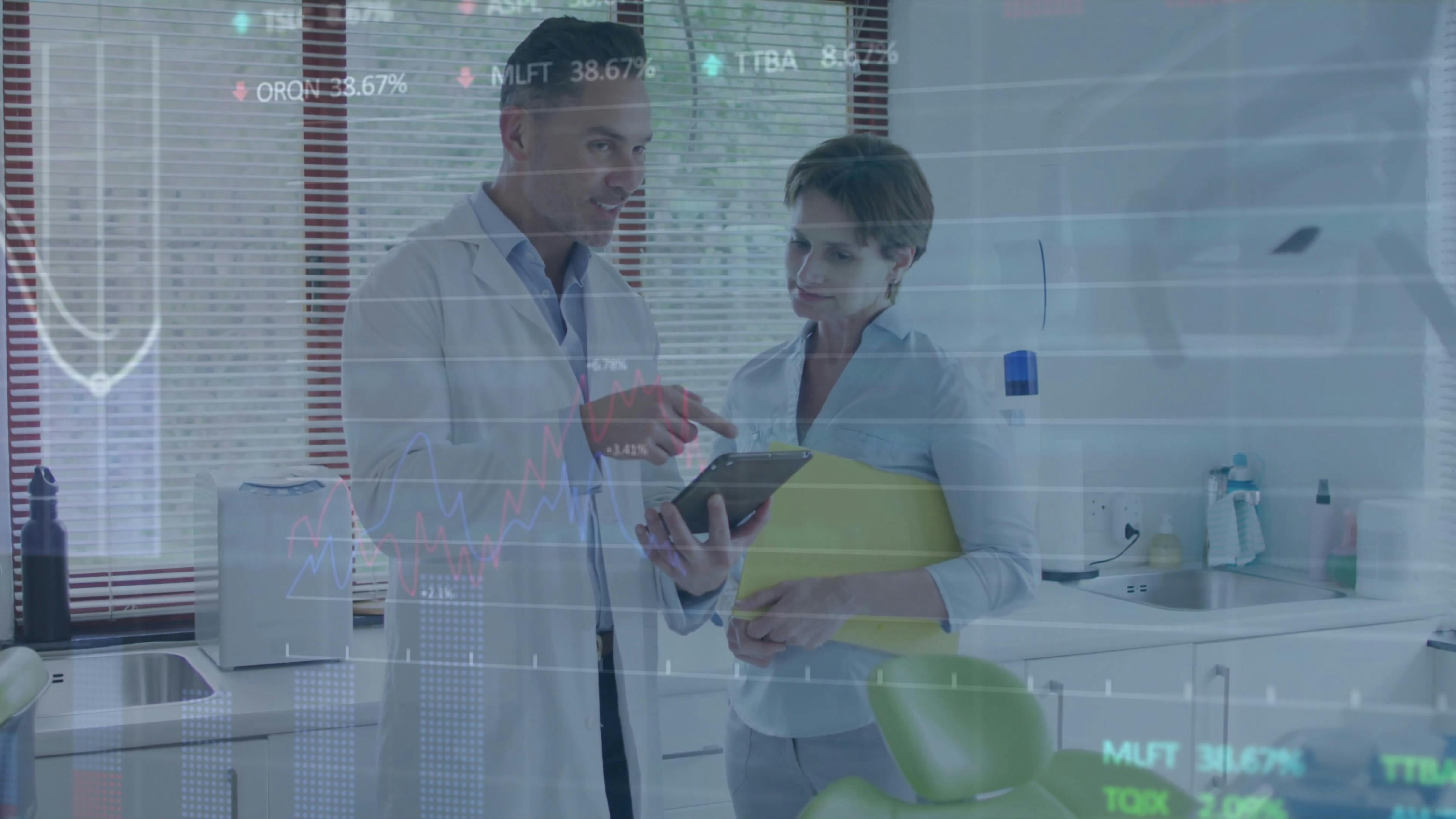 a dentist talking to an assistant about a patient's chart