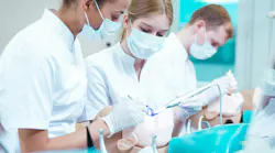 dental hygiene students working on a manikin