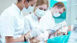dental hygiene students working on a manikin