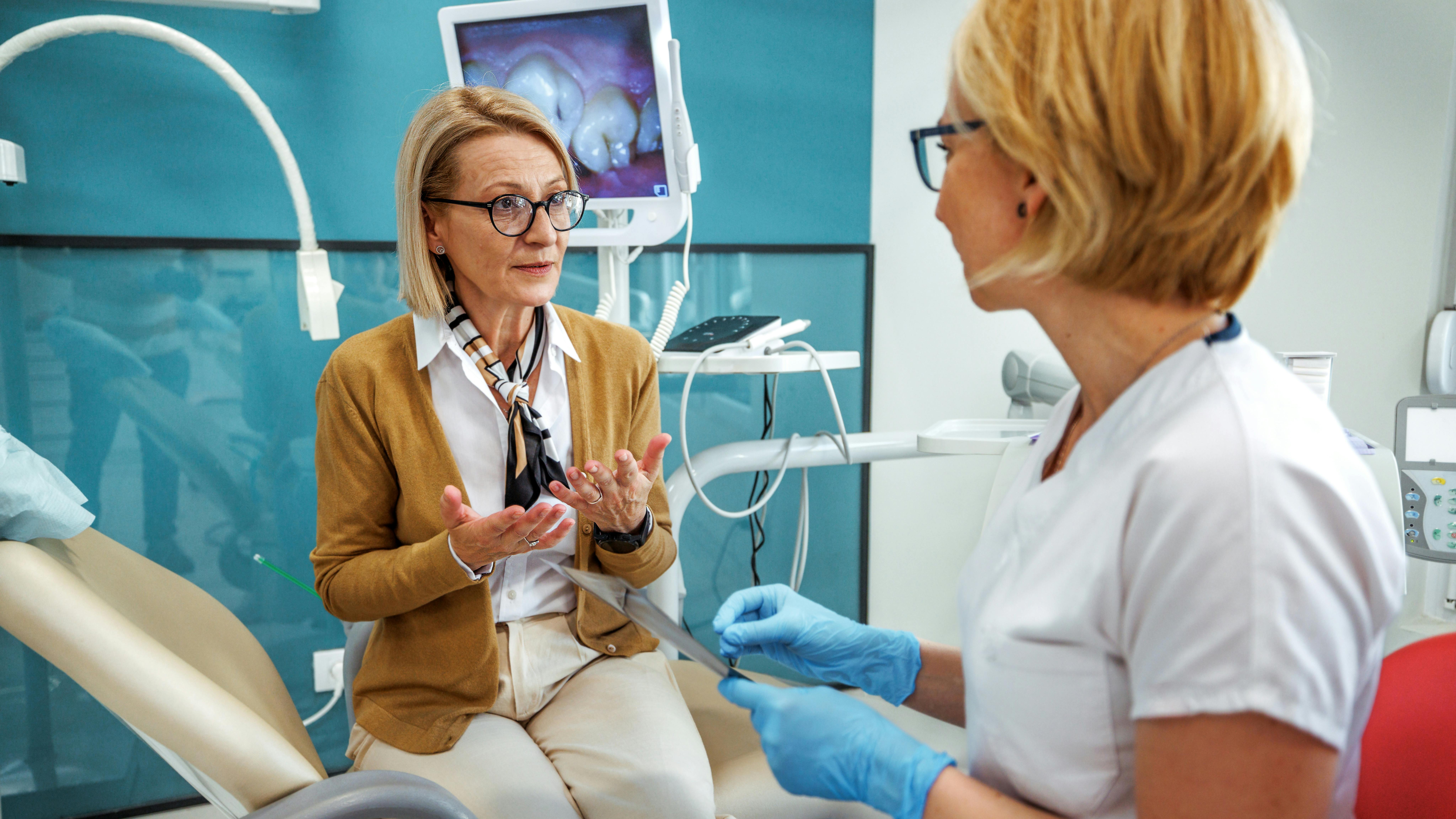 dental patient speaking with a dental professional