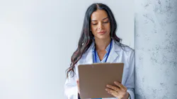 dental professional holding a patient chart